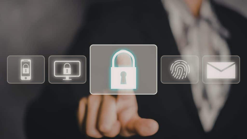 Person interacting with a digital interface showing a glowing padlock icon, representing multi factor authentification and data protection.